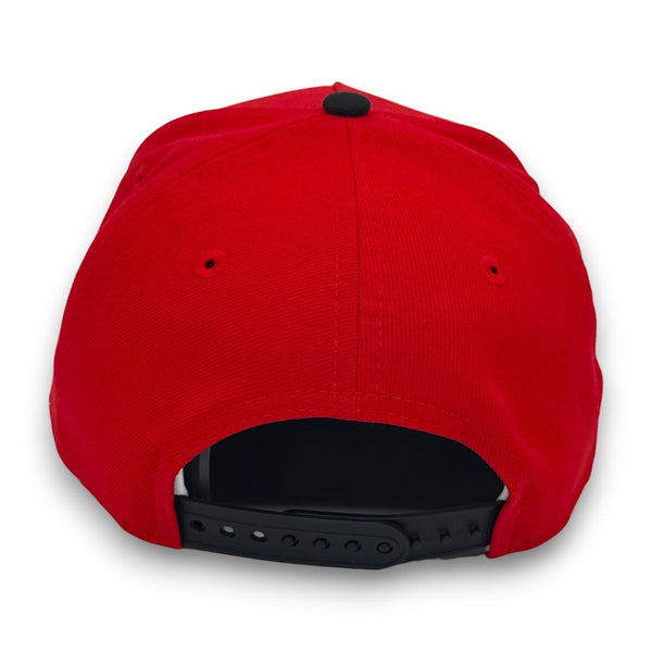 Red cap with a black strap on a white background