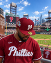 Classic Phillies 🔔 9.16.26 2pm ET A man wearing a Philadelphia Phillies red baseball cap and matching red jersey stands in Citizens Bank Park, looking down toward the field.