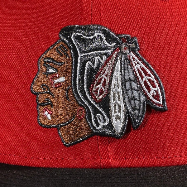 Embroidered logo on a red and black cap