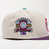 A light beige baseball cap featuring a prominent embroidered Chicago Cubs 1990 All-Star Game patch on the front, with a purple flat brim and a teal button on top.