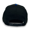 Black cap with a blue button on the back against a white background