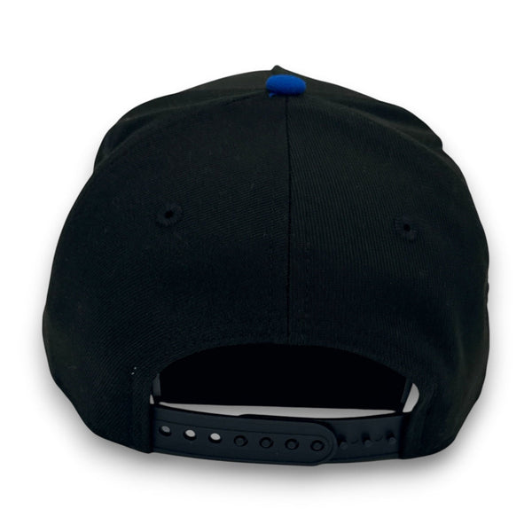 Black cap with a blue button on the back against a white background