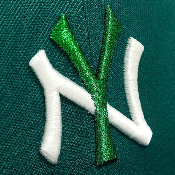 Embroidered logo on a green fabric background