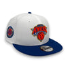 White and blue cap with New York Knicks logo on a white background