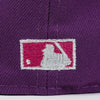 Close-up of a purple cap with a logo featuring a white silhouette of a person holding a bat on a pink background. The Pirates Brooklyn 42 ASG 59FIFTY Grape New Era Hat