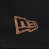 Close-up of a black fabric with an embroidered logo on a dark background. The Pirates Dbacks 98 59FIFTY Black New Era Hat