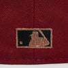 Close-up of a embroidered logo on a maroon fabric background