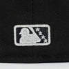 Embroidered logo on a black cap with a white silhouette of a person and stars. Bradenton Marauders