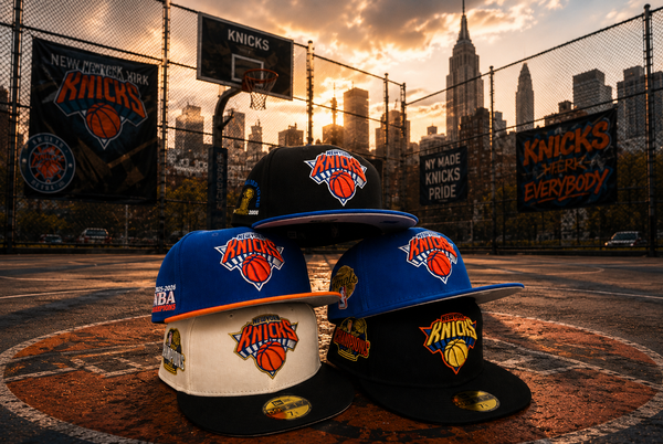 Three New York Knicks flat-brim caps stacked on a basketball court with a city skyline at sunset in the background. The hats include blue, cream, and black colorways, each featuring the Knicks logo.